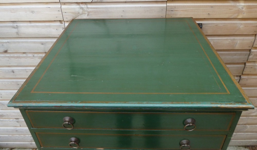 A tall dark green painted pine office chest featuring eight drawers with brass ring handles and gold pinstripe lining. View IV