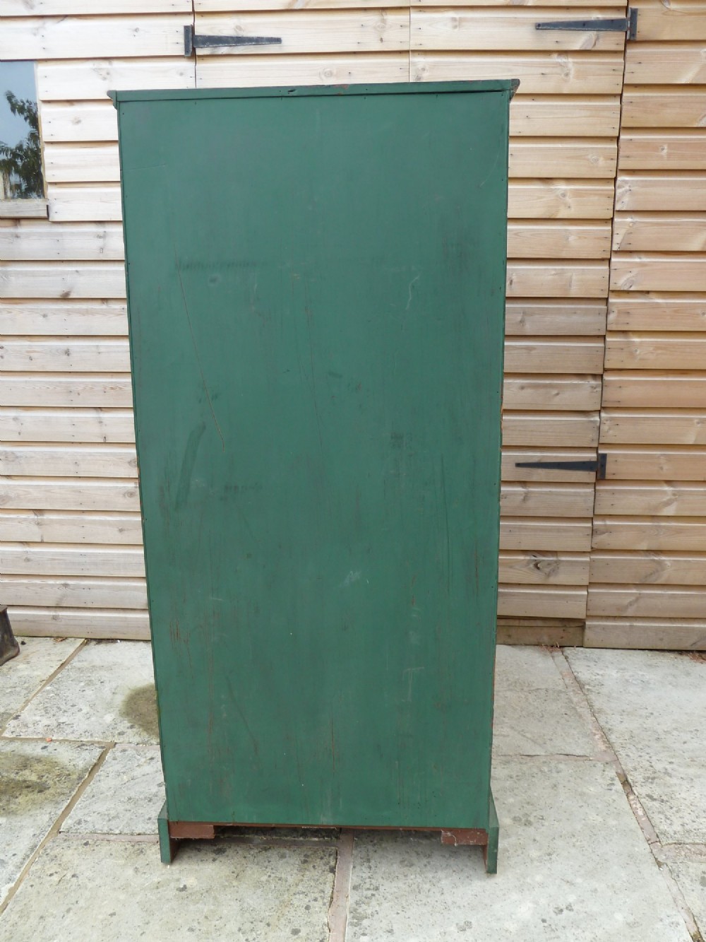 A tall dark green painted pine office chest featuring eight drawers with brass ring handles and gold pinstripe lining. View VI