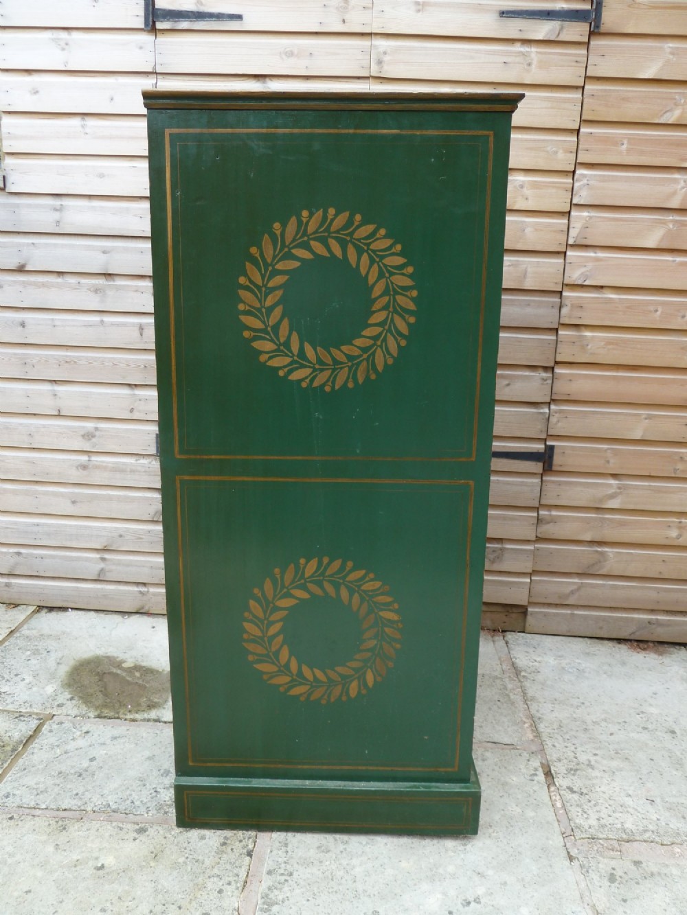 A tall dark green painted pine office chest featuring eight drawers with brass ring handles and gold pinstripe lining. View VII