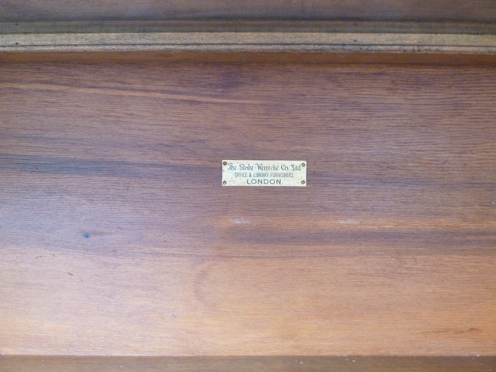 A four-tier medium oak Globe Wernicke sectional bookcase featuring glass up-and-over doors, a moulded top cornice, and a plinth base. View VIII