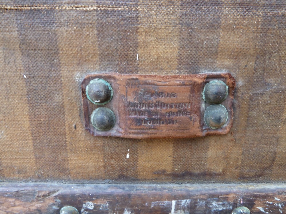 An open 19th-century flat-top steamer trunk featuring a brown striped canvas exterior, brass hardware, wood slatted bindings, and a cream quilted fabric interior lid lining. View VIII