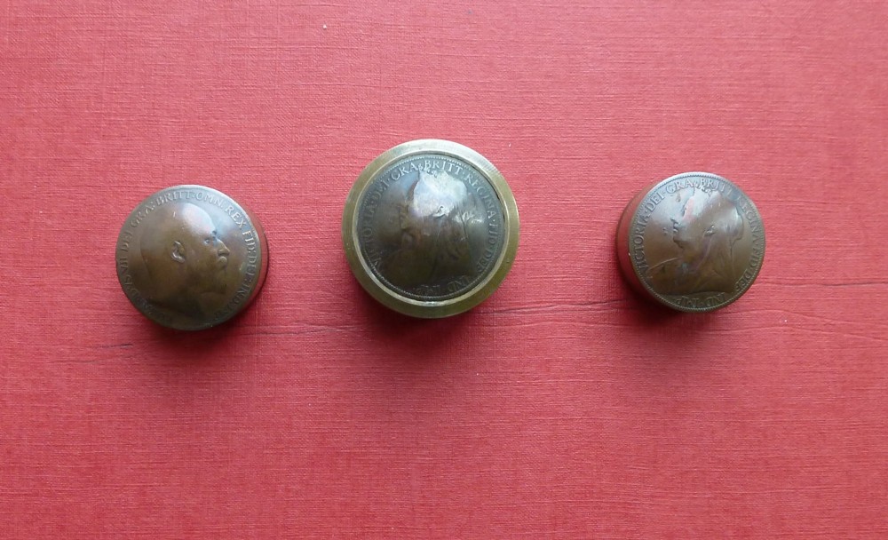 Three small circular antique brass snuff boxes with lids featuring raised profile portraits of British monarchs. View VII