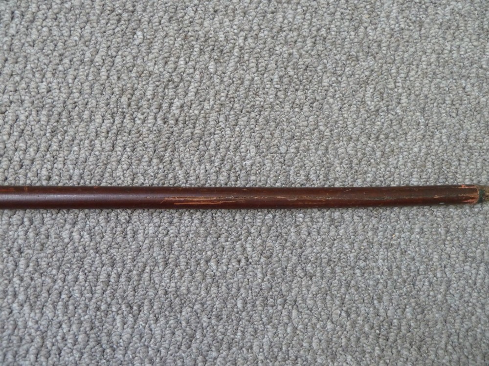 A Victorian sword stick displayed unsheathed in two parts, showcasing a stag horn handle, decorative metal ferrule, dark wooden scabbard, and a narrow steel blade. View VI