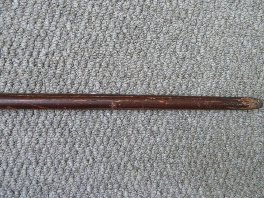A Victorian sword stick displayed unsheathed in two parts, showcasing a stag horn handle, decorative metal ferrule, dark wooden scabbard, and a narrow steel blade. View VII