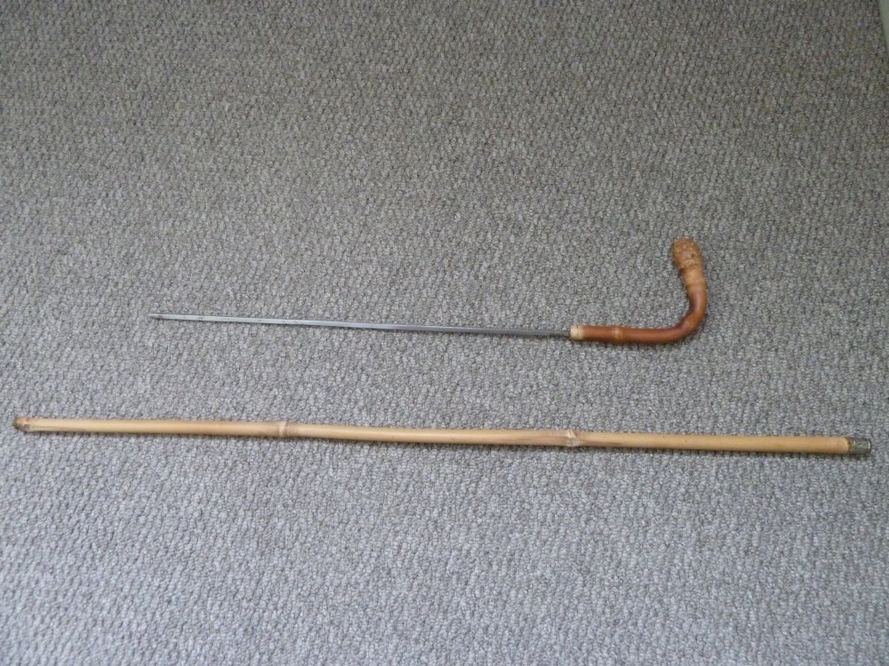 A Victorian bamboo walking stick displayed unsheathed alongside its concealed long steel blade attached to a curved bamboo crook handle. View II