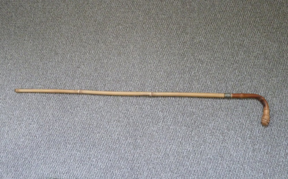 A Victorian bamboo walking stick displayed unsheathed alongside its concealed long steel blade attached to a curved bamboo crook handle. View VII