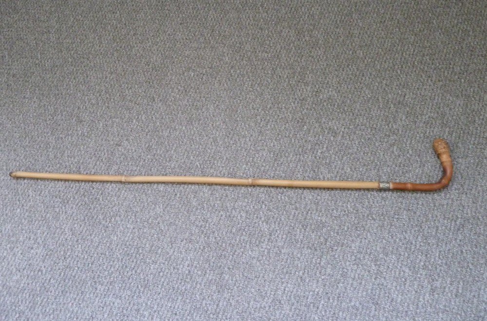 A Victorian bamboo walking stick displayed unsheathed alongside its concealed long steel blade attached to a curved bamboo crook handle. View VIII