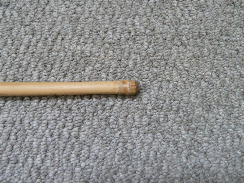 A Victorian bamboo walking stick displayed unsheathed alongside its concealed long steel blade attached to a curved bamboo crook handle. View IX