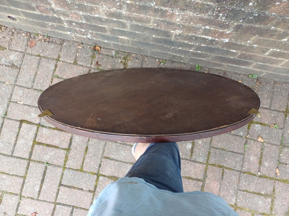 A large horizontal oval wall mirror featuring a carved mahogany wooden frame and a bevelled glass edge. View IX