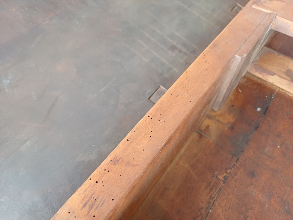 An antique mahogany drop-leaf dining table with one hinged leaf raised, standing on tapered legs with pad feet. View XII