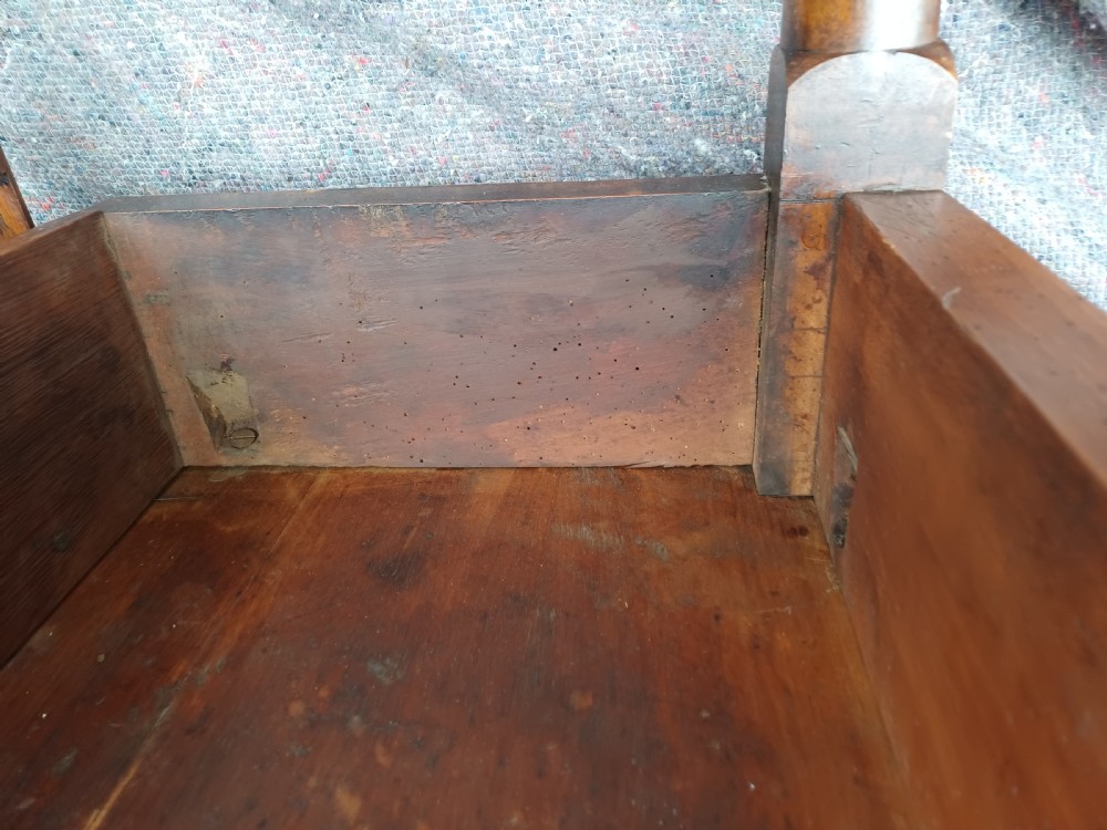 An antique mahogany drop-leaf dining table with one hinged leaf raised, standing on tapered legs with pad feet. View XIII