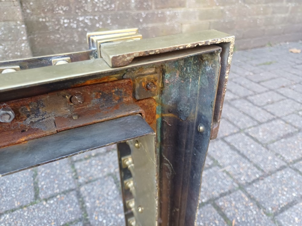 An antique brass fireplace fender featuring a turned spindle balustrade, spherical corner finials, and a stepped plinth base. View XIX