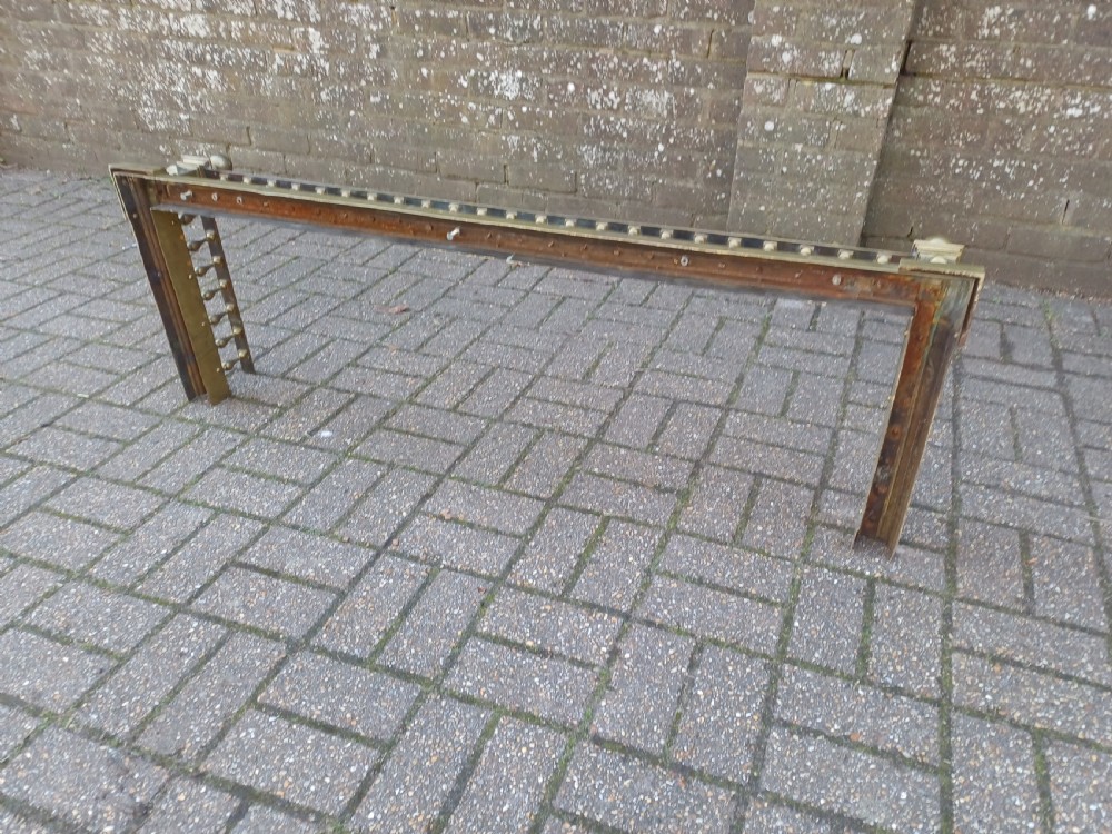 An antique brass fireplace fender featuring a turned spindle balustrade, spherical corner finials, and a stepped plinth base. View XX