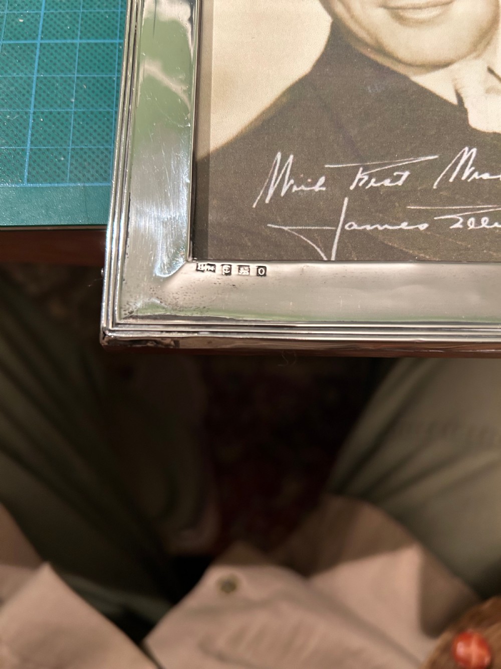 A pair of Edwardian hallmarked sterling silver picture frames with arched tops and floral relief moulding housing vintage black and white portrait photographs. View VIII