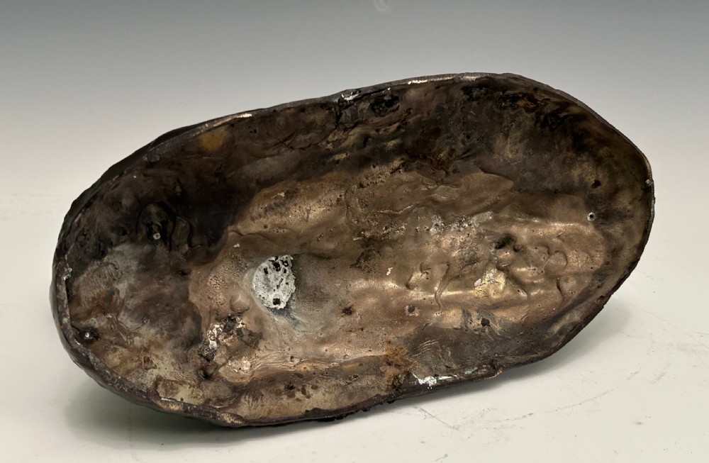 A dark brown patinated bronze sculpture depicting an alert standing greyhound on a textured naturalistic base. View IV