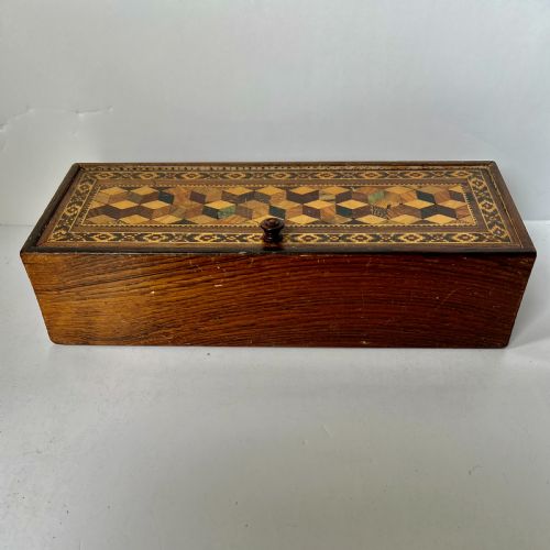 fig 1. A rectangular Victorian Tunbridge ware wooden glove box with a floral mosaic top panel and a geometric inlaid border.
