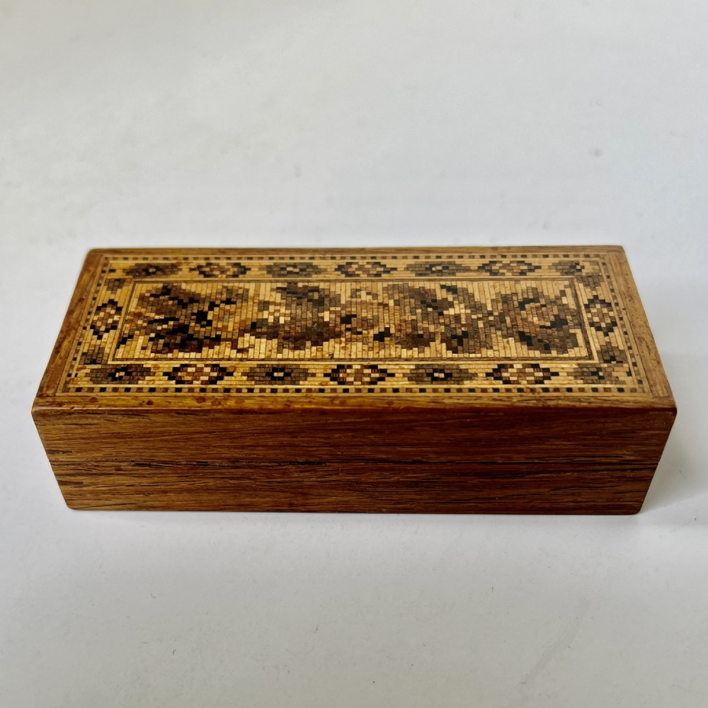 A small rectangular Victorian rosewood trinket box featuring a flat lid decorated with detailed geometric wooden mosaic marquetry. View II
