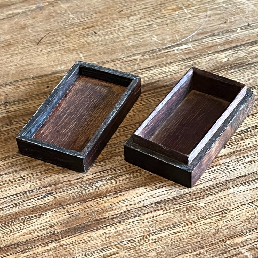 A small rectangular Victorian wooden pin box featuring geometric parquetry inlay in contrasting light and dark woods across the lid. View II
