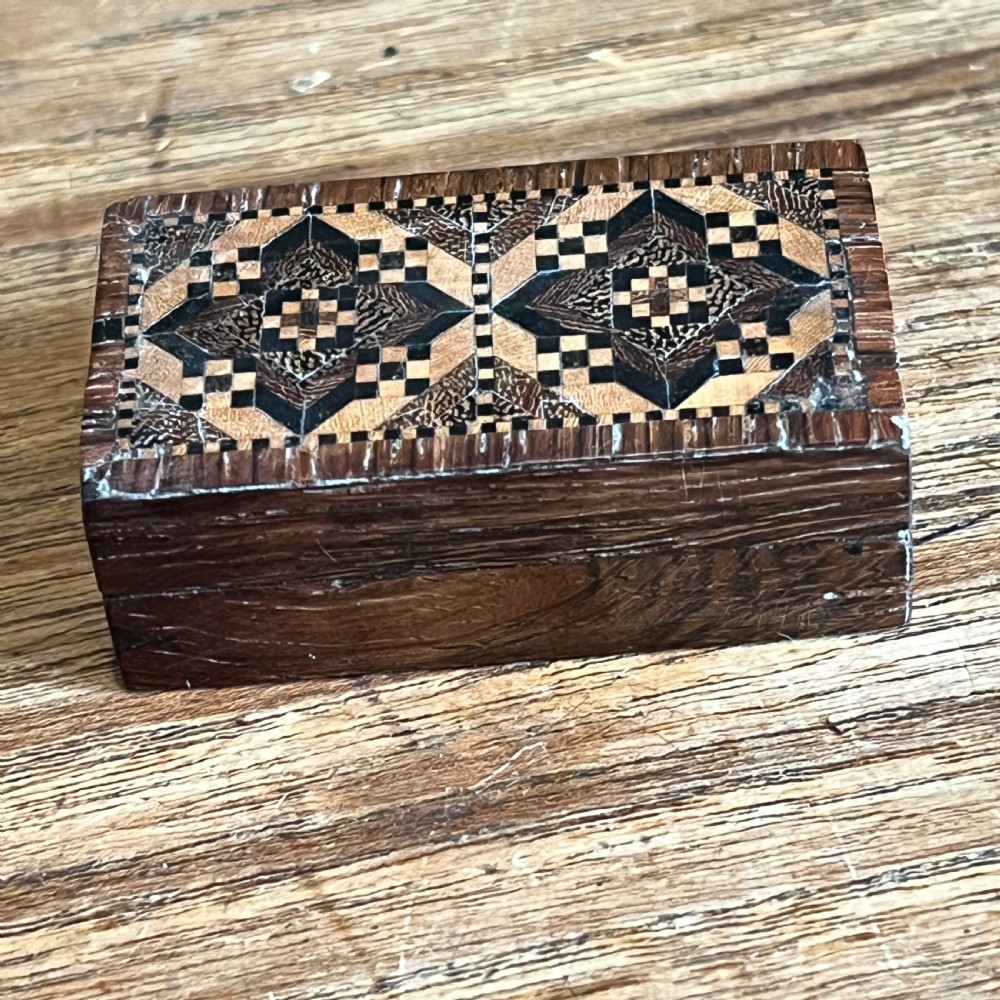 A small rectangular Victorian wooden pin box featuring geometric parquetry inlay in contrasting light and dark woods across the lid. View III