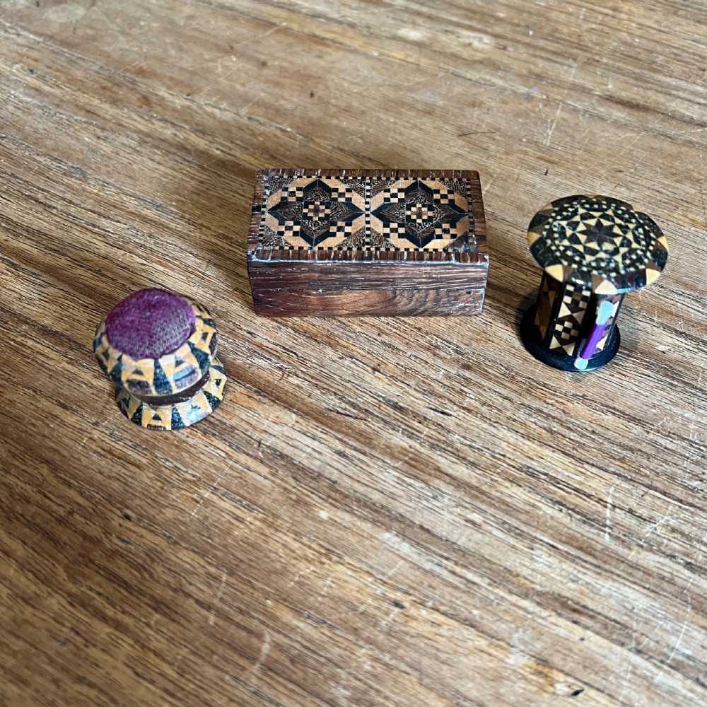 A small rectangular Victorian wooden pin box featuring geometric parquetry inlay in contrasting light and dark woods across the lid. View VI