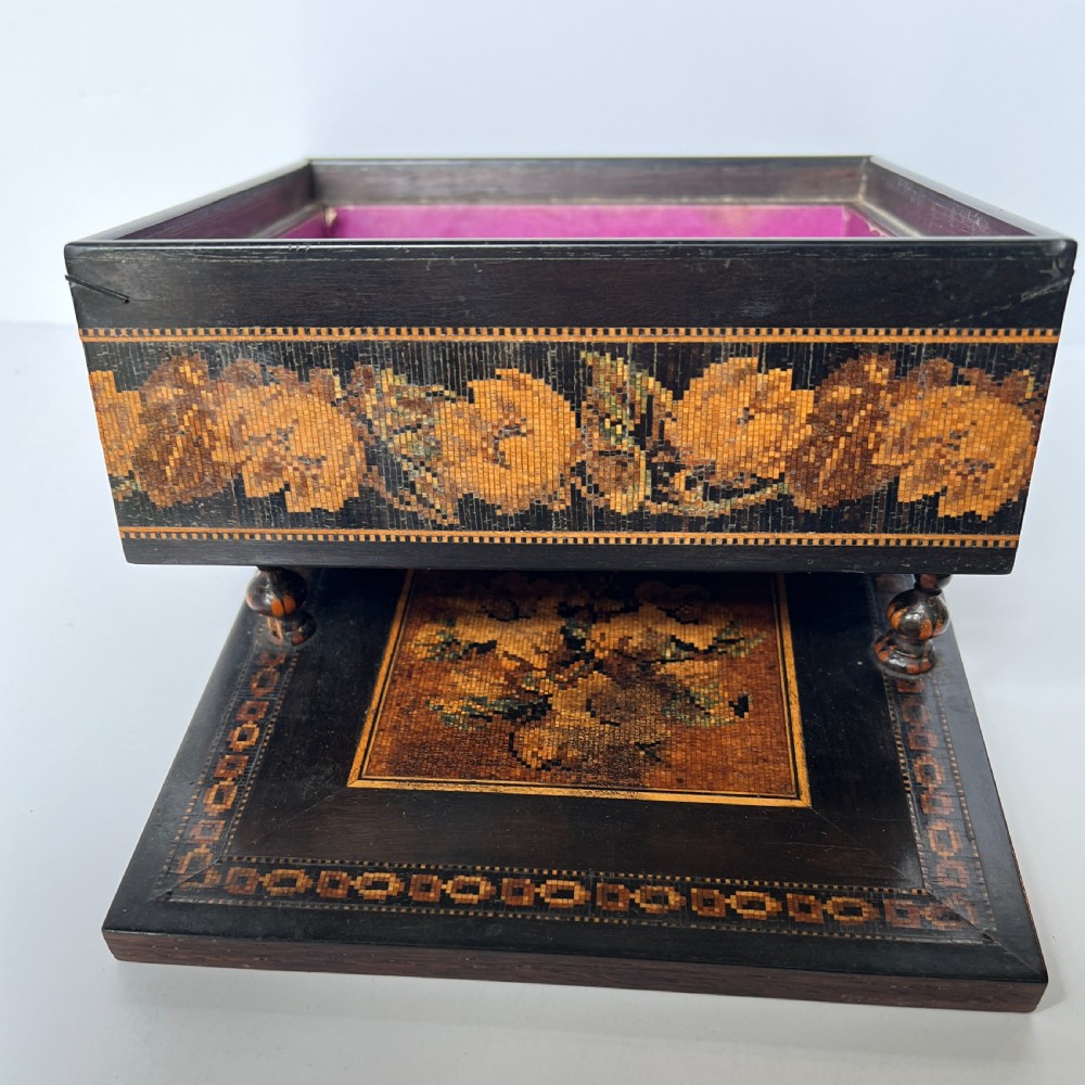 A dark rosewood Tunbridge ware box featuring a micro-mosaic floral border around the sides and turned wooden finials on the top lid. View VI