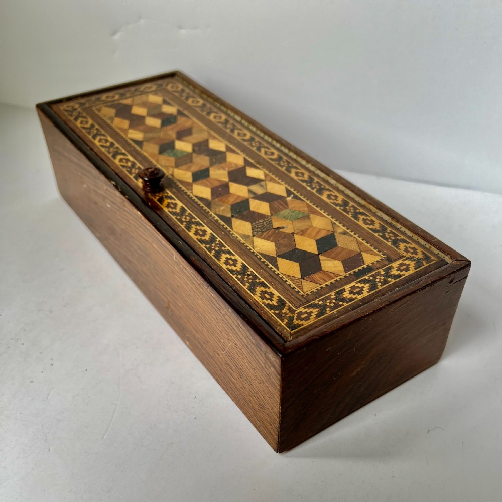 A Victorian Tunbridge ware rectangular wooden glove box featuring intricate geometric tessellated wood marquetry and a small turned knob. View III