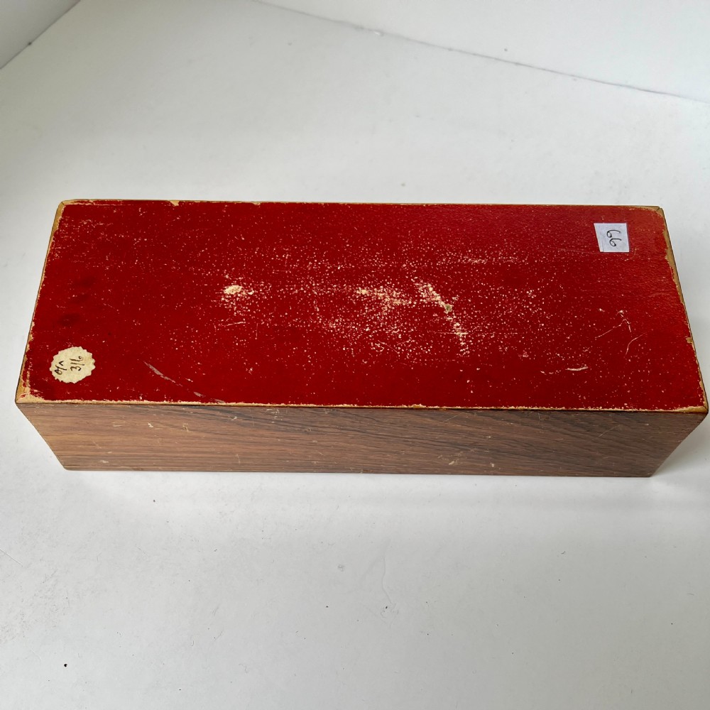 A Victorian Tunbridge ware rectangular wooden glove box featuring intricate geometric tessellated wood marquetry and a small turned knob. View V