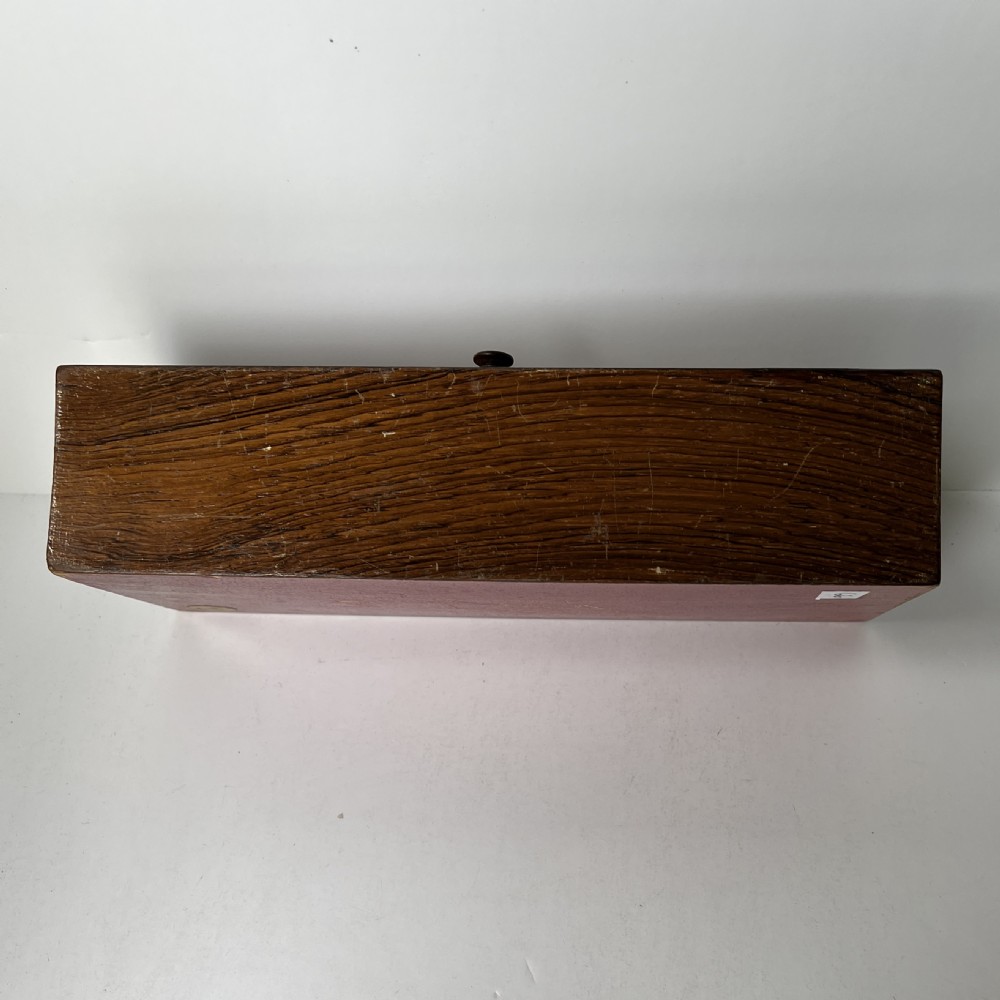 A Victorian Tunbridge ware rectangular wooden glove box featuring intricate geometric tessellated wood marquetry and a small turned knob. View VI