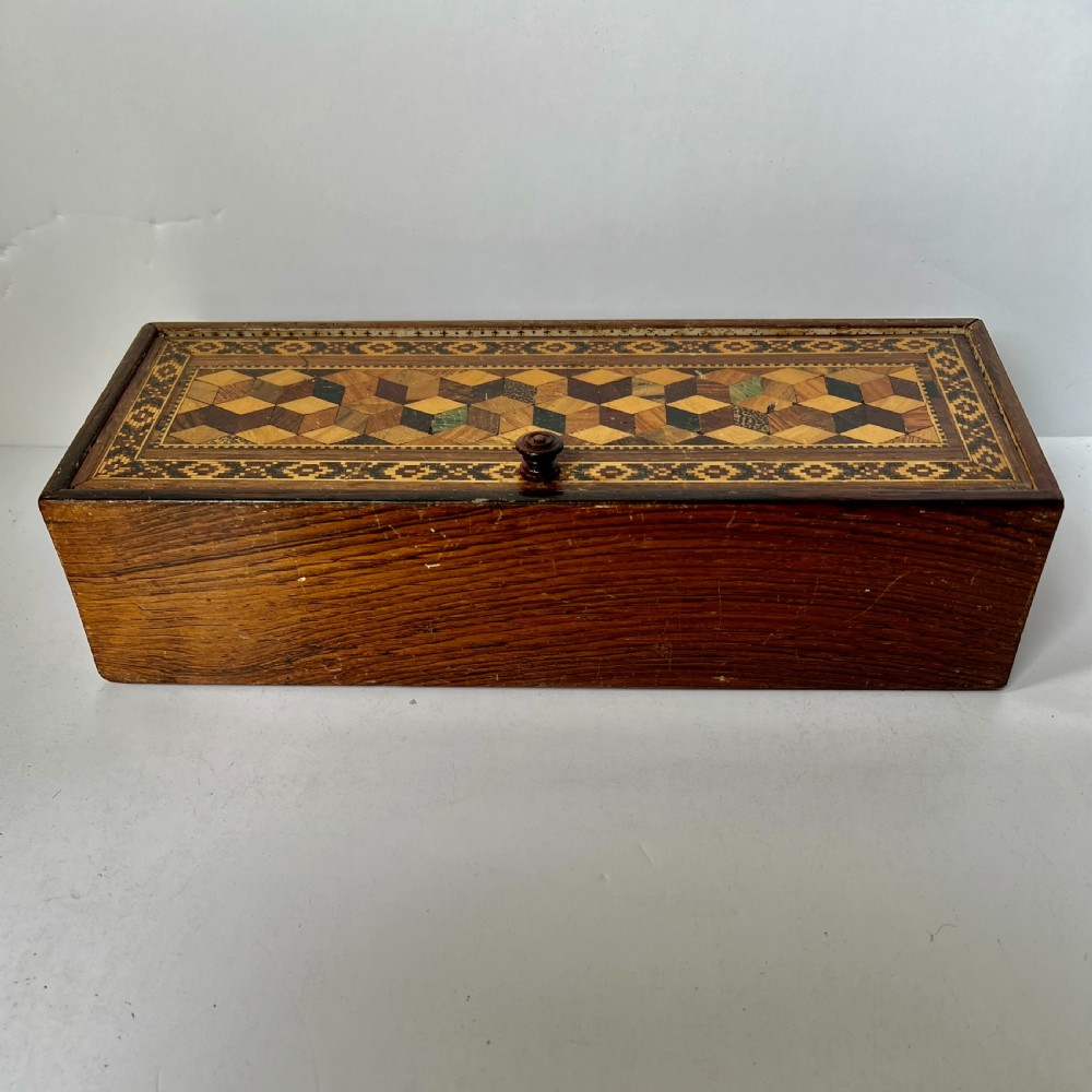 A rectangular Victorian Tunbridge ware wooden glove box with a floral mosaic top panel and a geometric inlaid border. View II