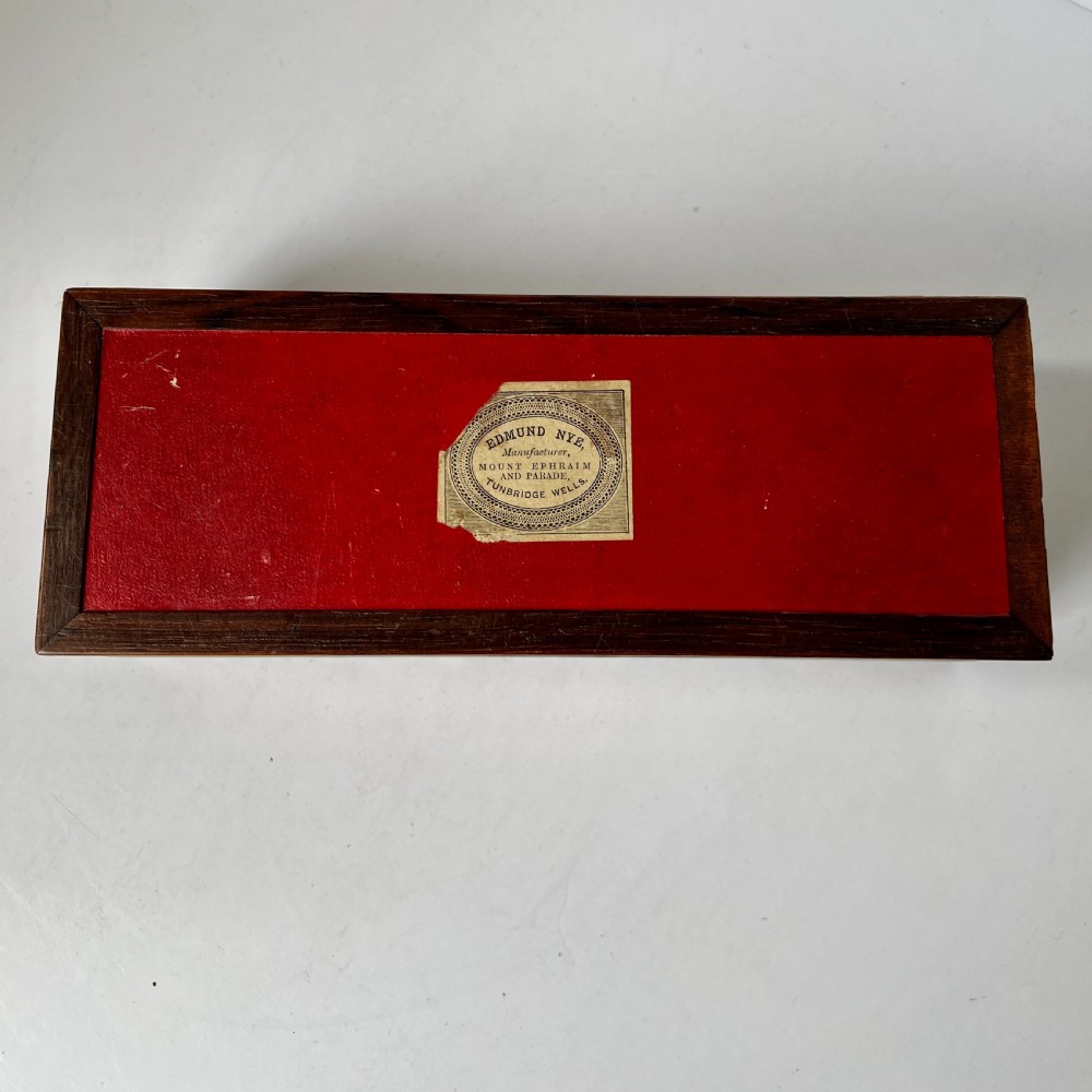 A rectangular Victorian Tunbridge ware wooden glove box with a floral mosaic top panel and a geometric inlaid border. View V
