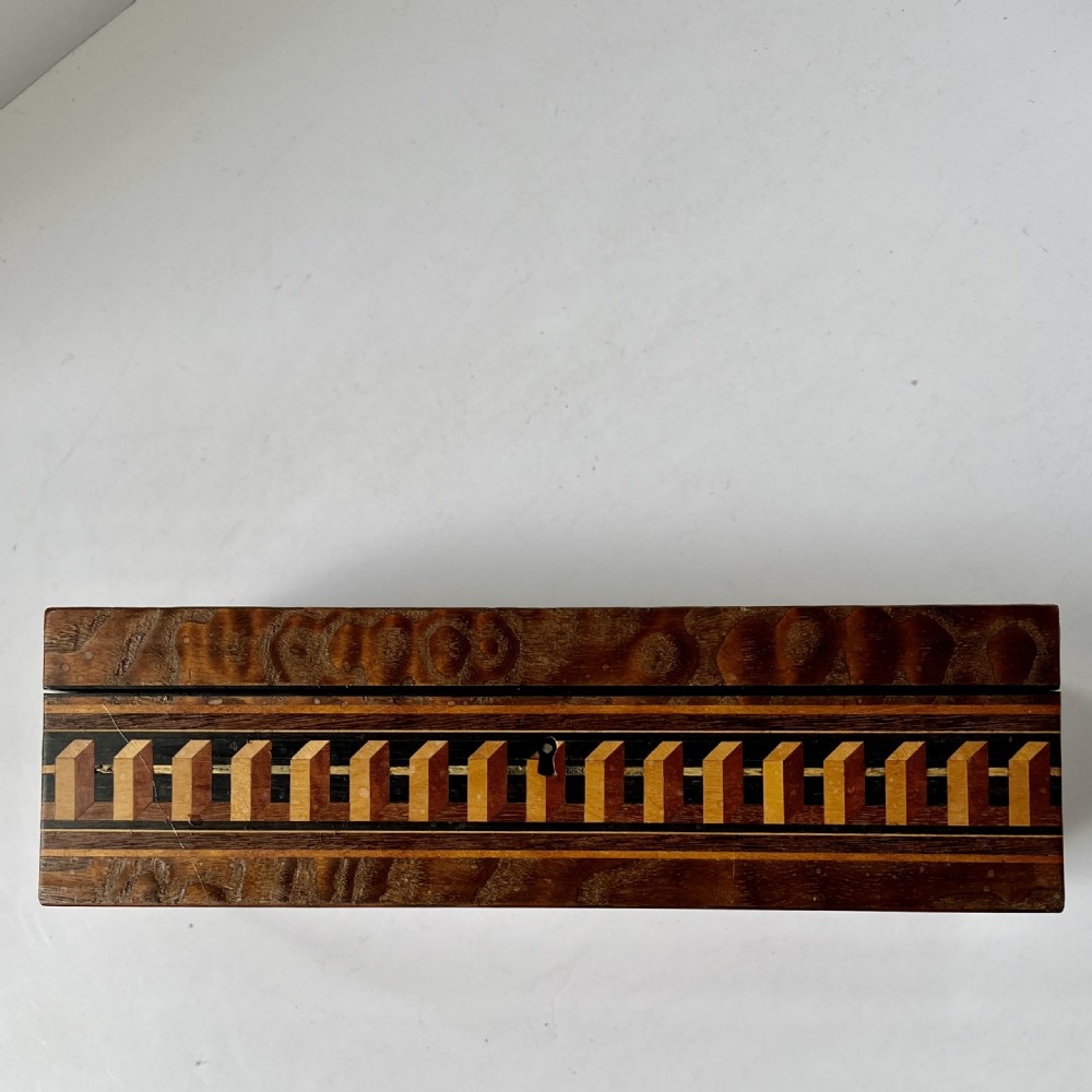 A rectangular Victorian Tunbridge ware wooden glove box with a floral mosaic top panel and a geometric inlaid border. View VIII