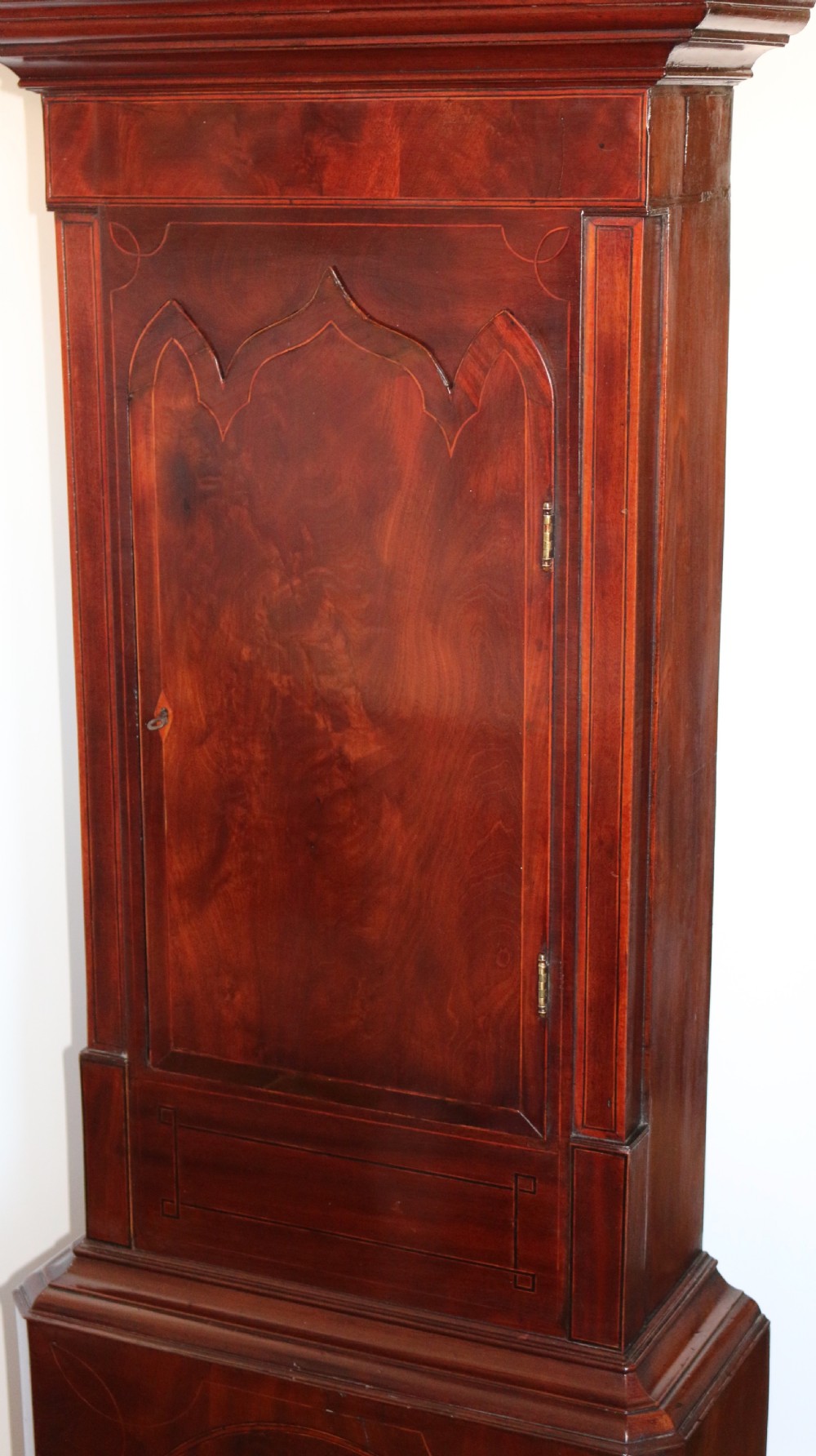 A Georgian mahogany longcase clock featuring a swan-neck pediment, a hand-painted dial with auxiliary subdials, and a rocking ship automaton in the arch. View VII