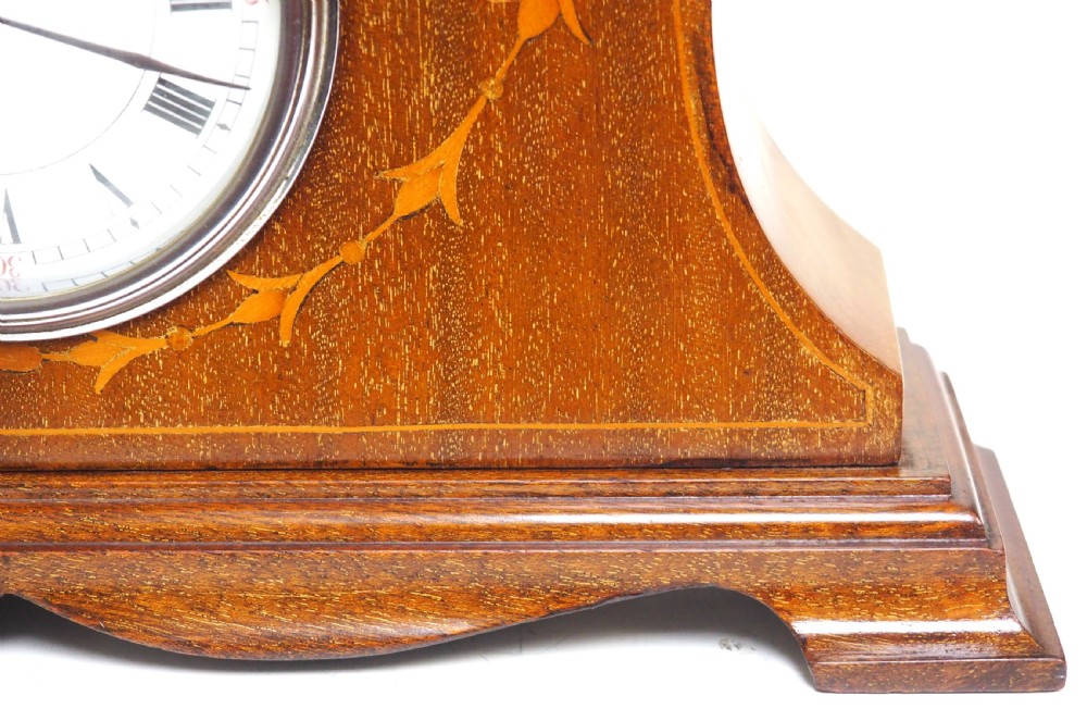 An Edwardian mahogany mantel clock featuring a stepped tulip-top case, floral marquetry inlay, and a white circular dial with Roman numerals. View III