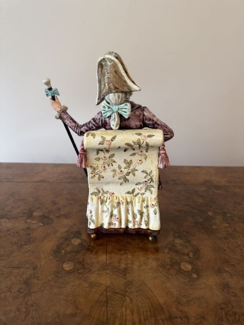 fig 1. A pair of antique Victorian painted porcelain musical figures depicting a lady and a gentleman dressed in eighteenth-century costume seated on floral armchairs.