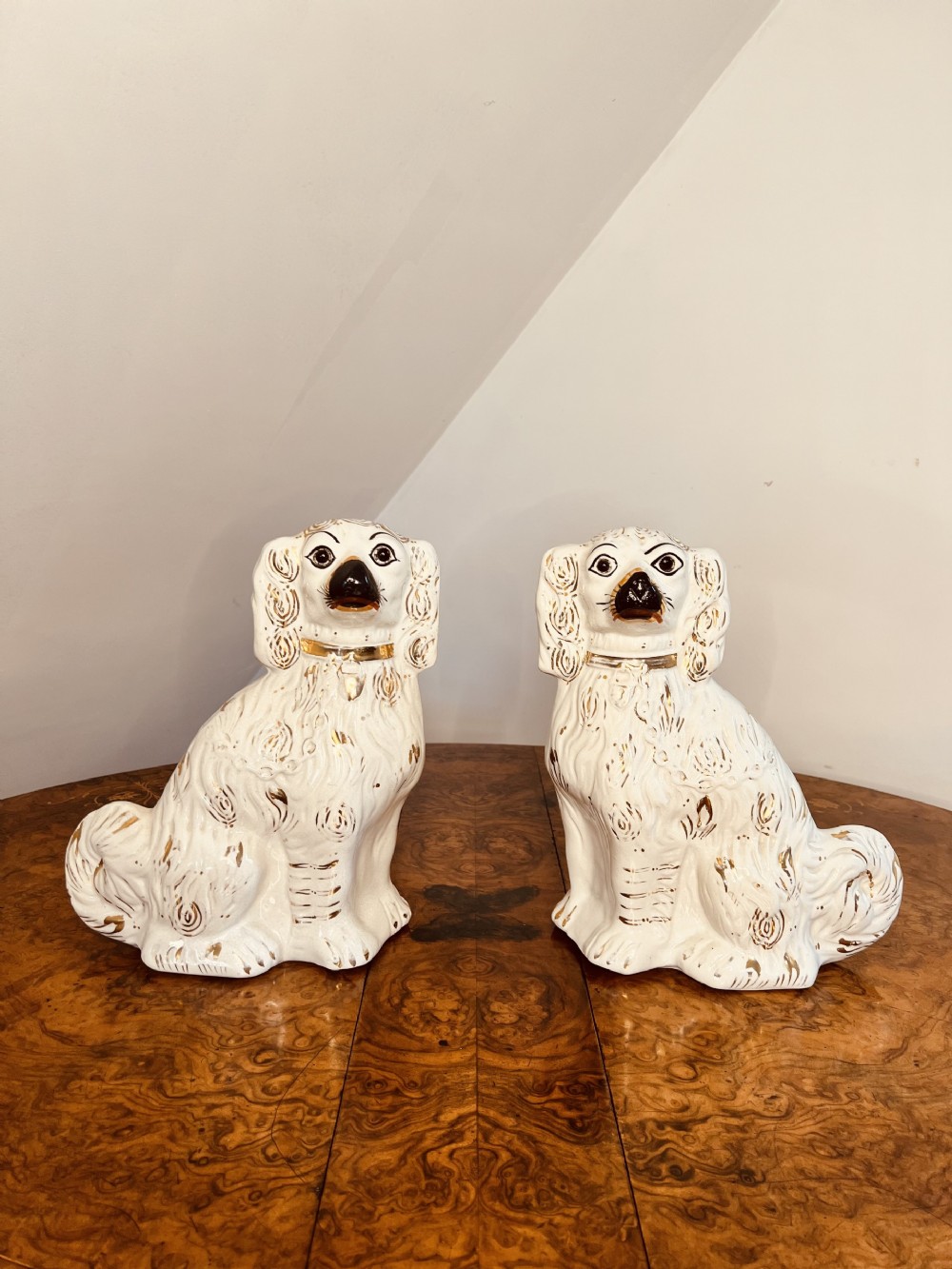 Charming pair of antique Victorian Staffordshire seated spaniels 