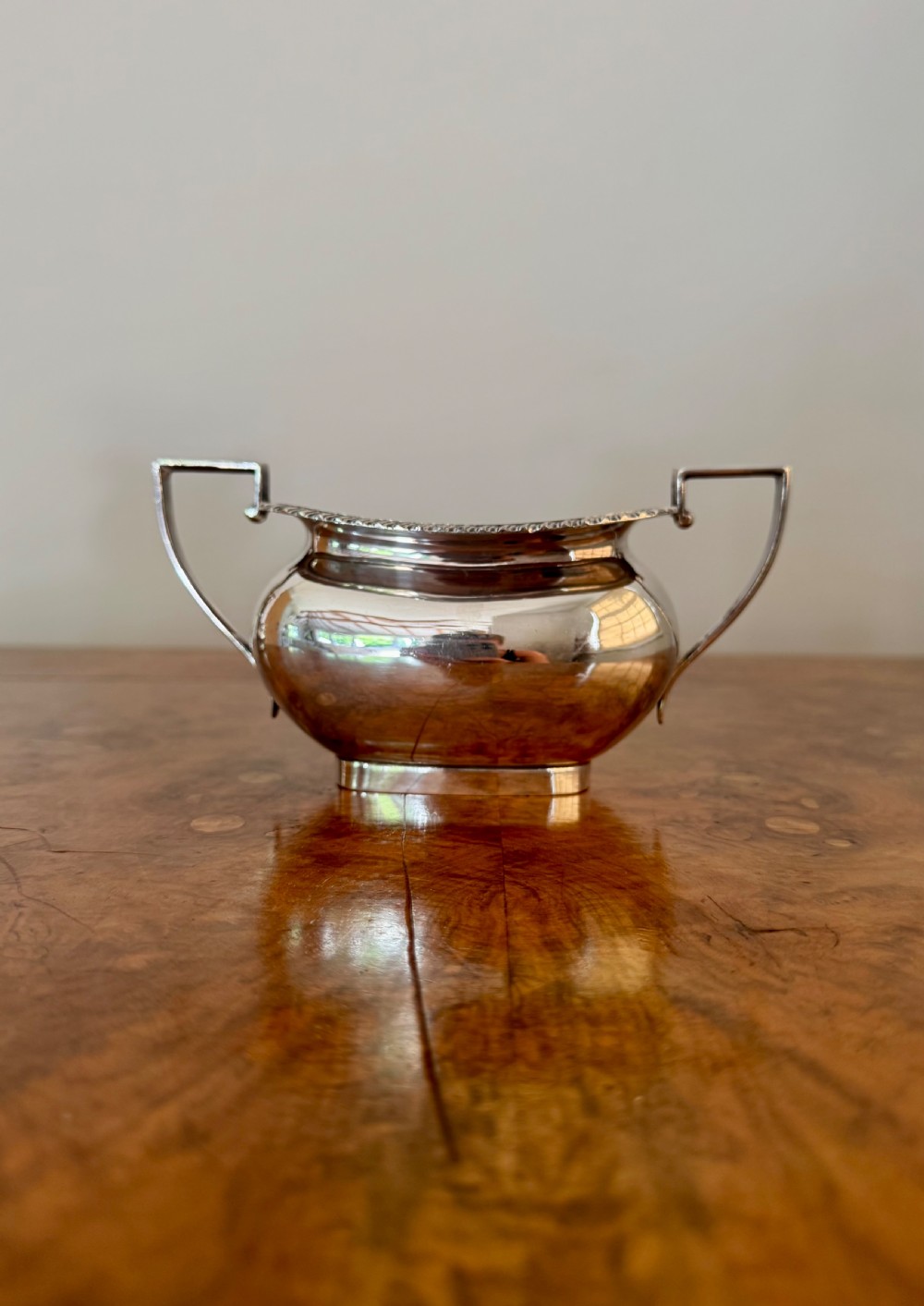 A four-piece Edwardian silver tea set comprising a teapot, coffee pot, cream jug, and sugar bowl with black wooden handles. View V