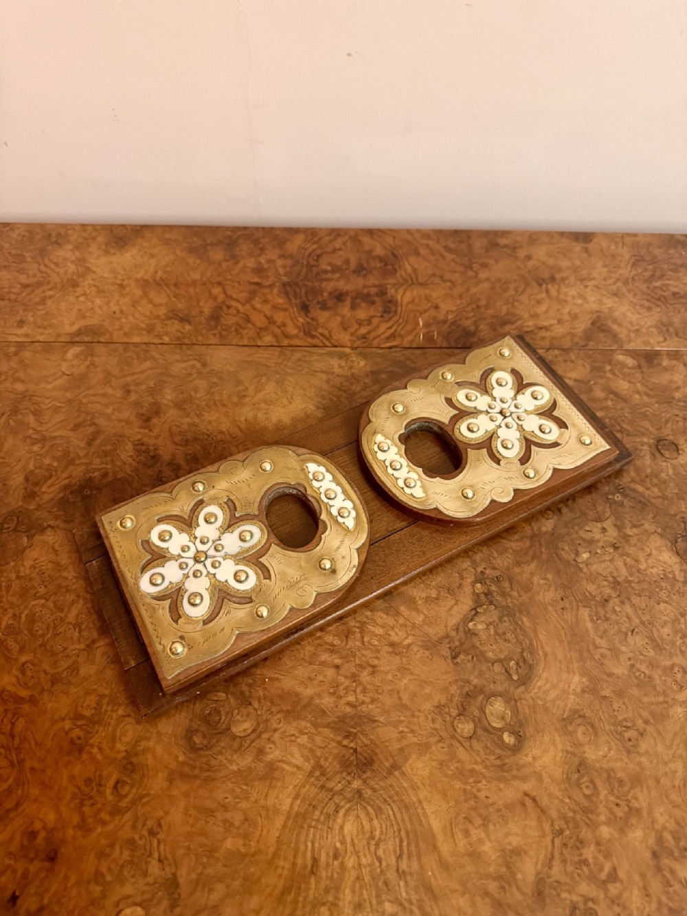 An antique Victorian dark walnut expanding book slide featuring fold-down ends decorated with engraved brass floral plates and white bone inlays.