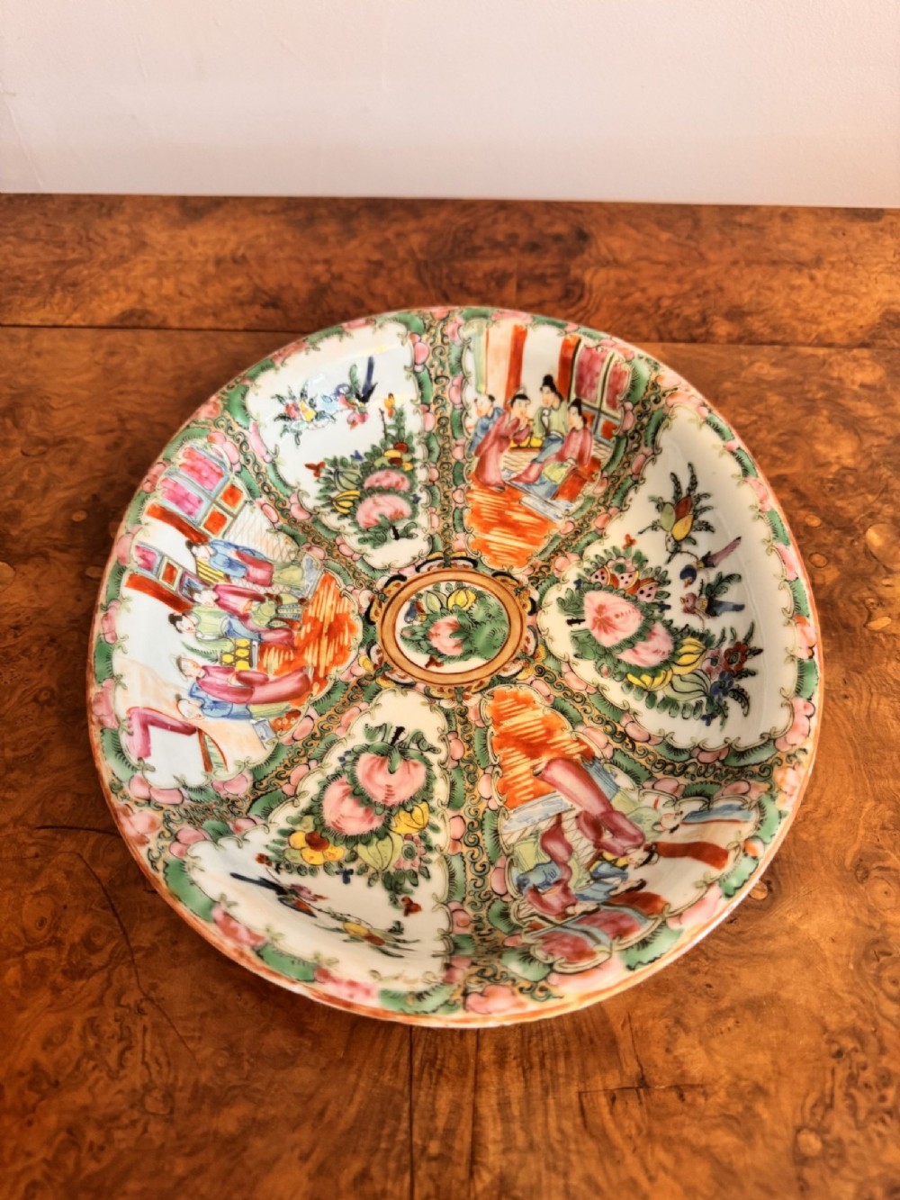 An oval 19th-century Chinese export porcelain dish painted with Rose Medallion panels featuring figures, birds, and flowers in pink and green enamels. View VII