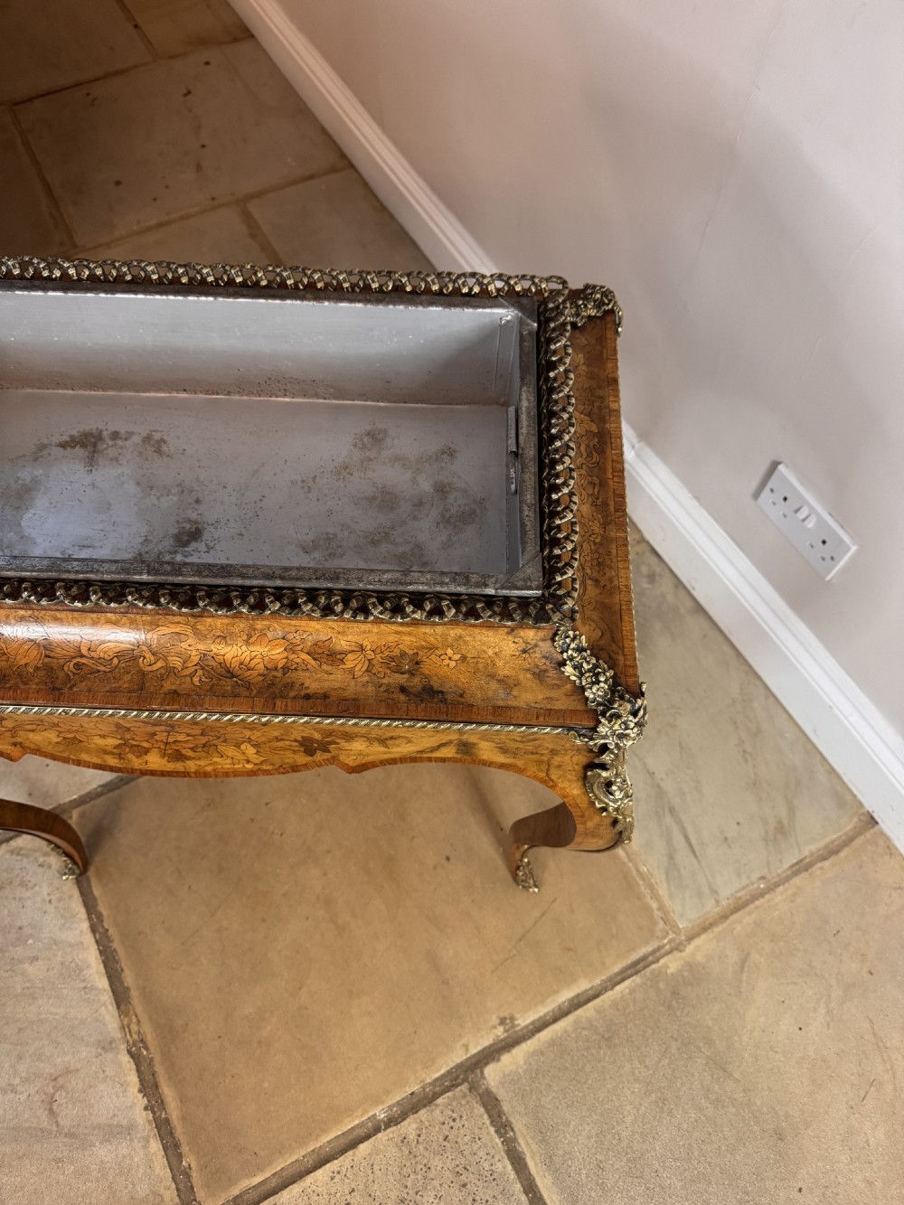 A Victorian walnut jardiniere table featuring intricate floral marquetry inlay, sweeping cabriole legs with decorative metal mounts, and a recessed metal liner. View IV