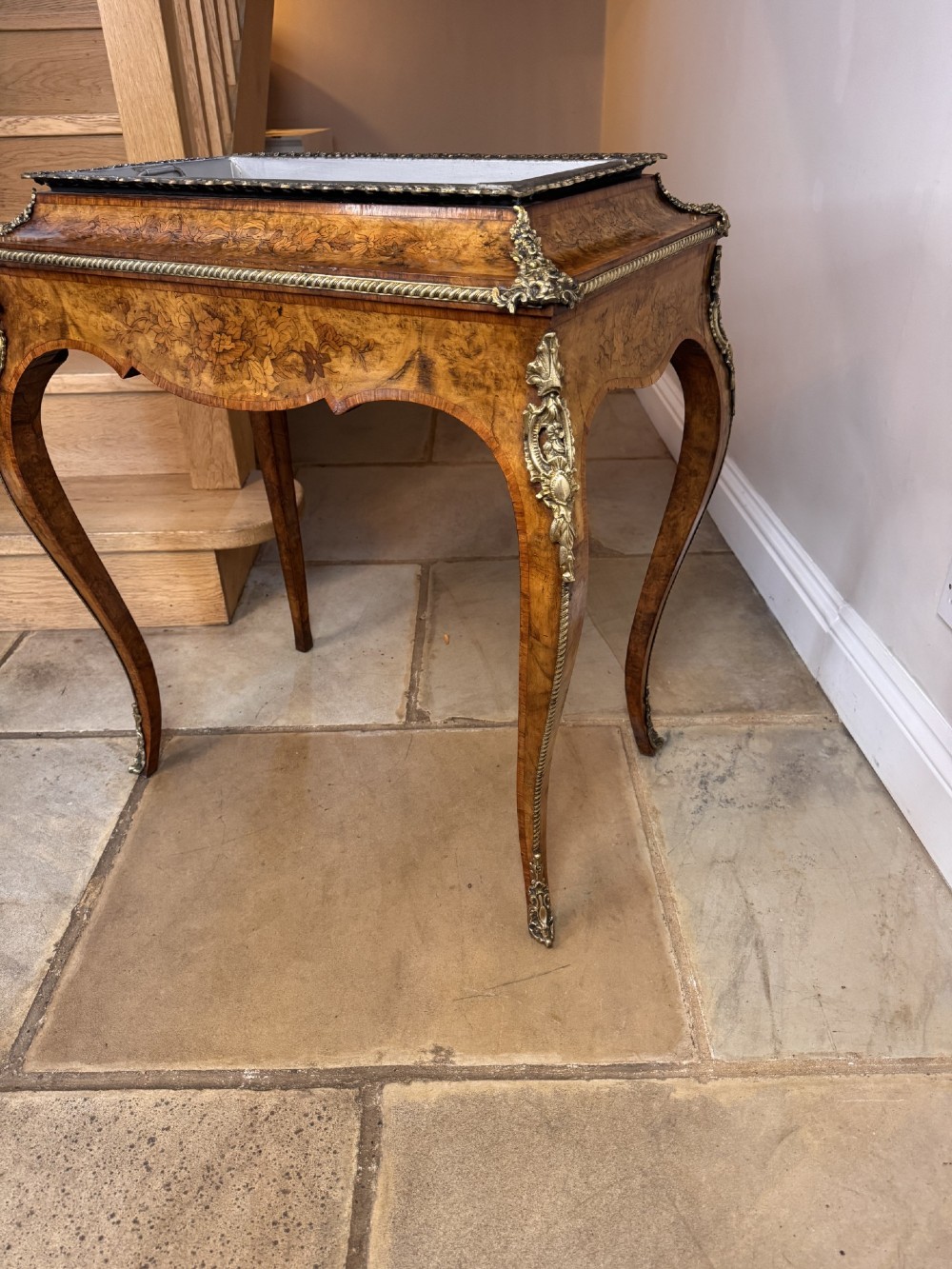 A Victorian walnut jardiniere table featuring intricate floral marquetry inlay, sweeping cabriole legs with decorative metal mounts, and a recessed metal liner. View V