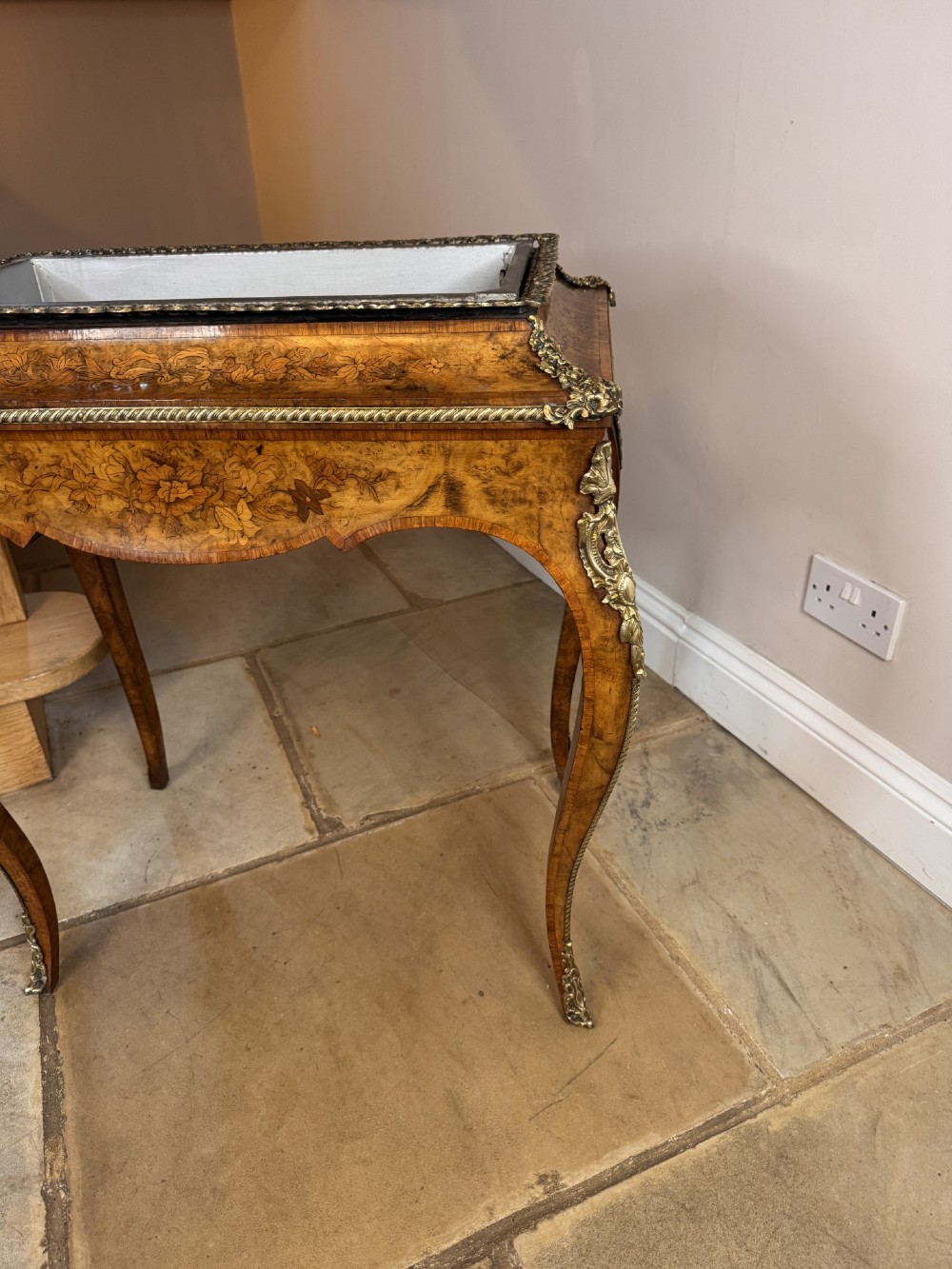 A Victorian walnut jardiniere table featuring intricate floral marquetry inlay, sweeping cabriole legs with decorative metal mounts, and a recessed metal liner. View VI