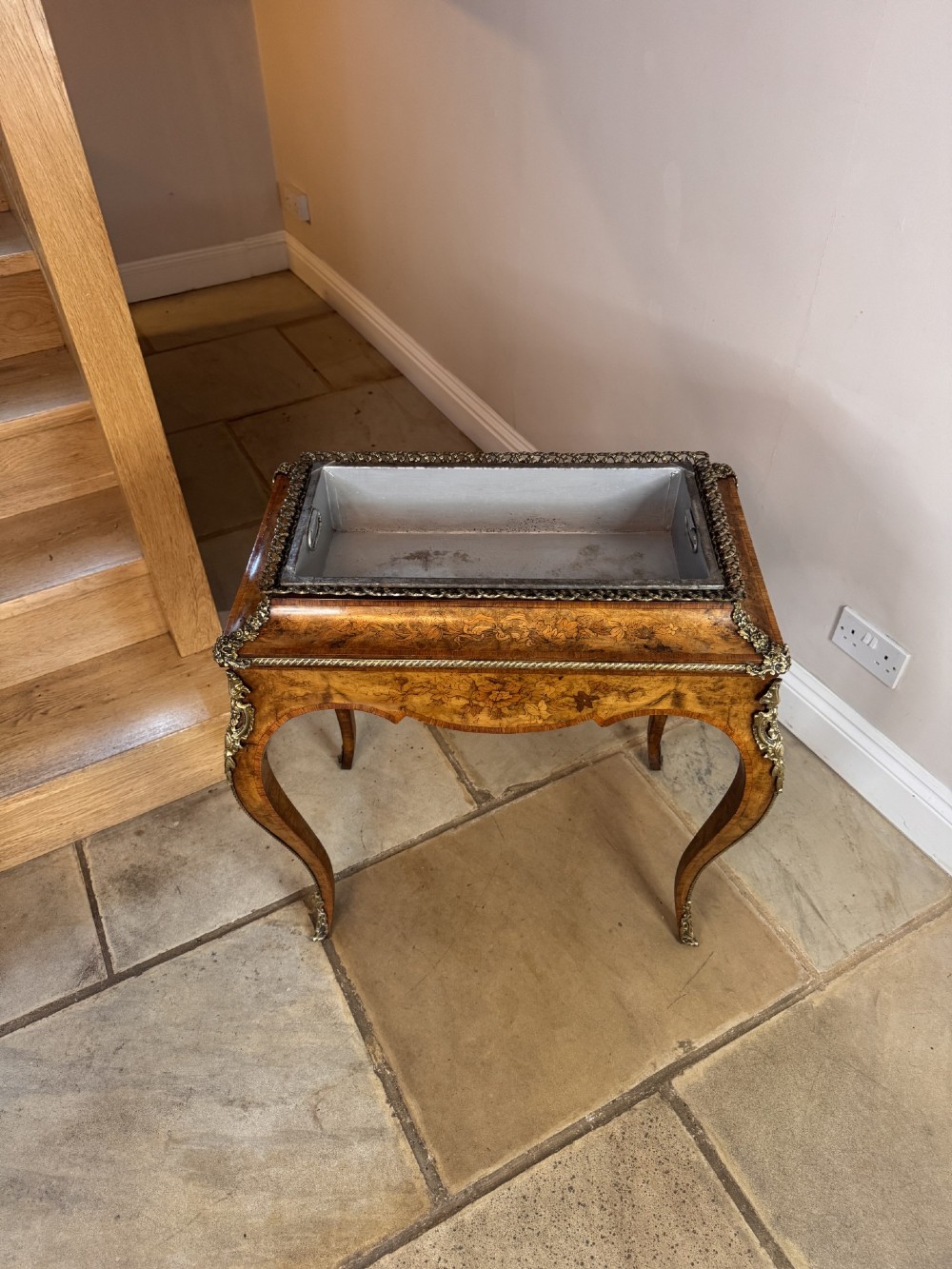 A Victorian walnut jardiniere table featuring intricate floral marquetry inlay, sweeping cabriole legs with decorative metal mounts, and a recessed metal liner. View VII