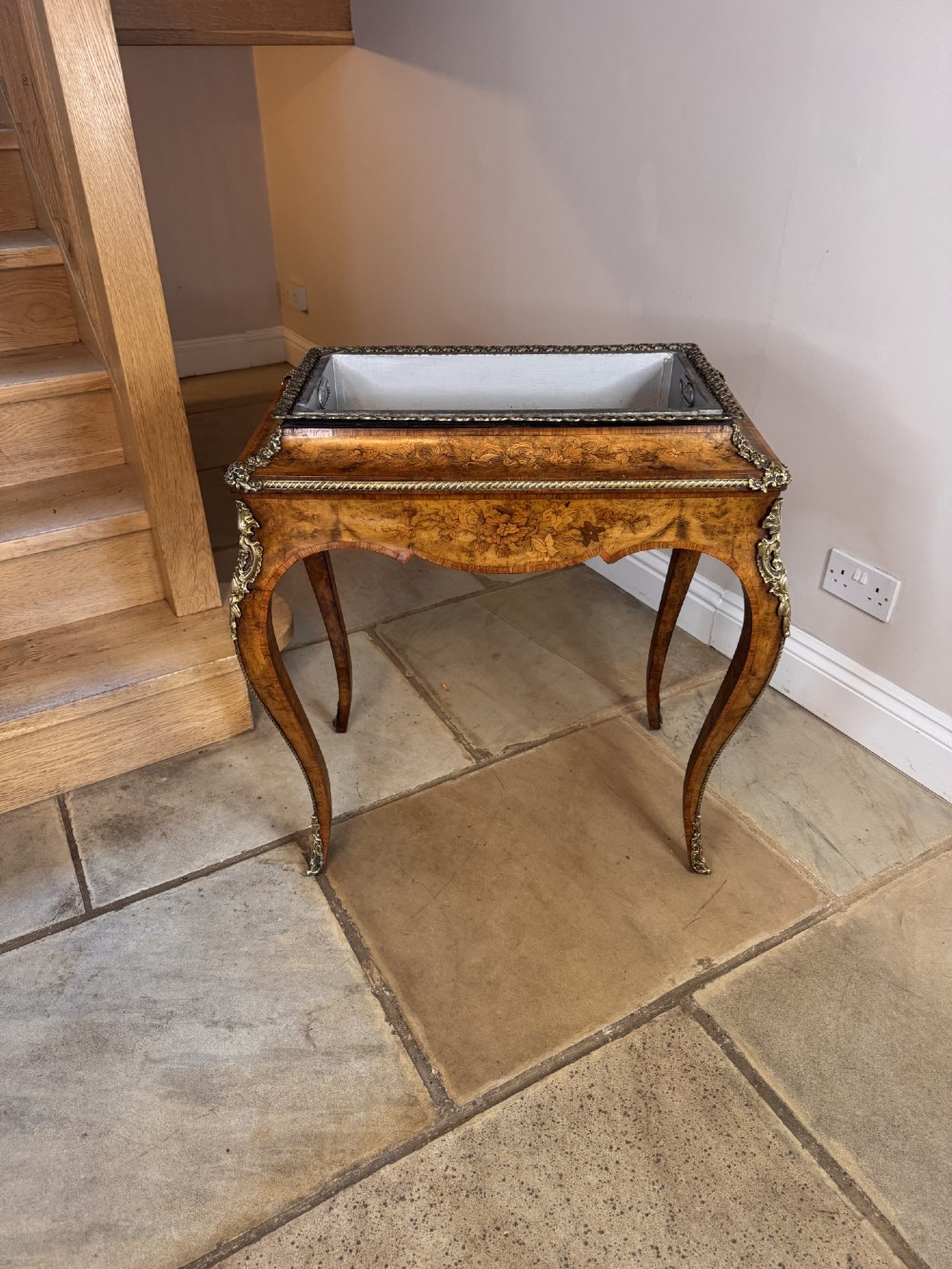 A Victorian walnut jardiniere table featuring intricate floral marquetry inlay, sweeping cabriole legs with decorative metal mounts, and a recessed metal liner. View VIII
