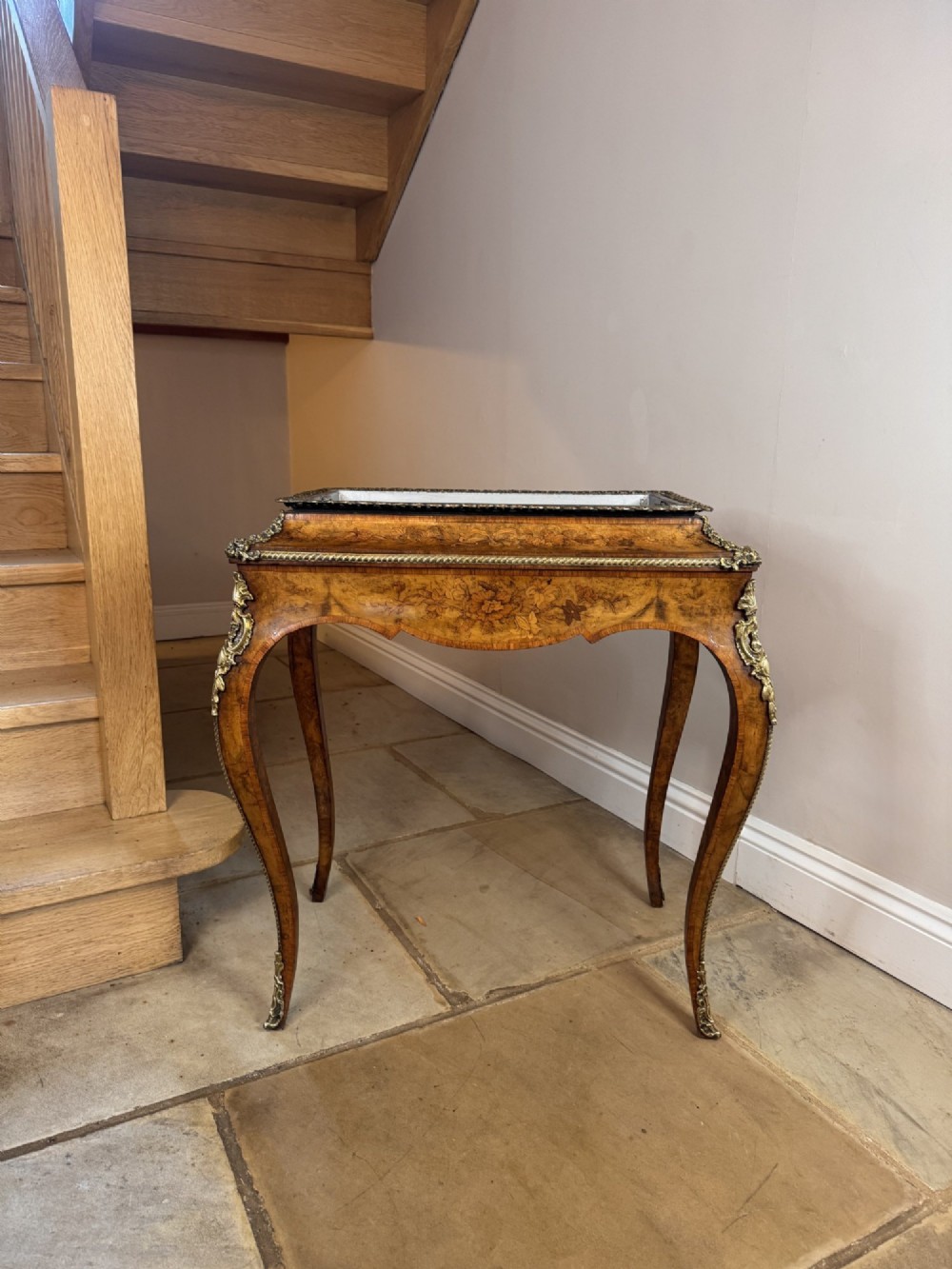 A Victorian walnut jardiniere table featuring intricate floral marquetry inlay, sweeping cabriole legs with decorative metal mounts, and a recessed metal liner. View IX