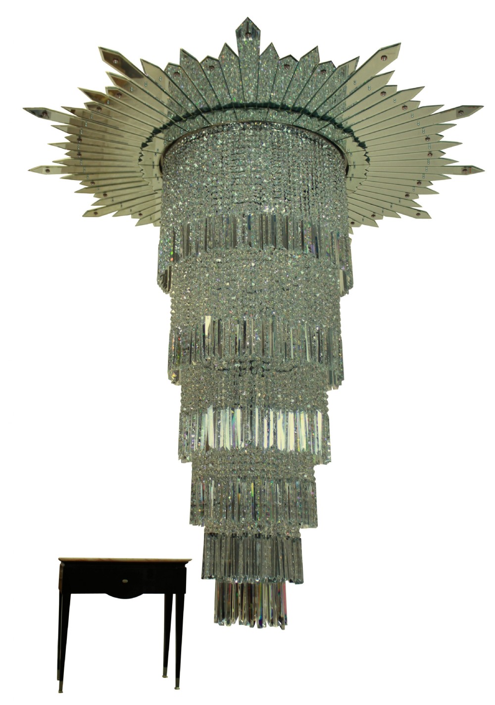 A monumental tiered Art Deco chandelier featuring a sunburst mirrored corona above cascading cylindrical layers of crystal prisms. View VI