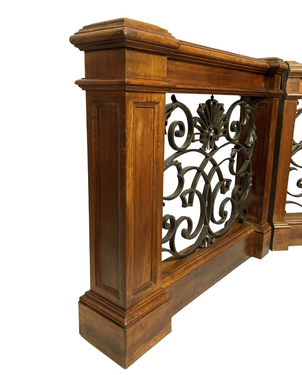 A pair of wooden-framed architectural balustrades featuring central wrought iron panels with scrolled patterns and fan motifs. View V