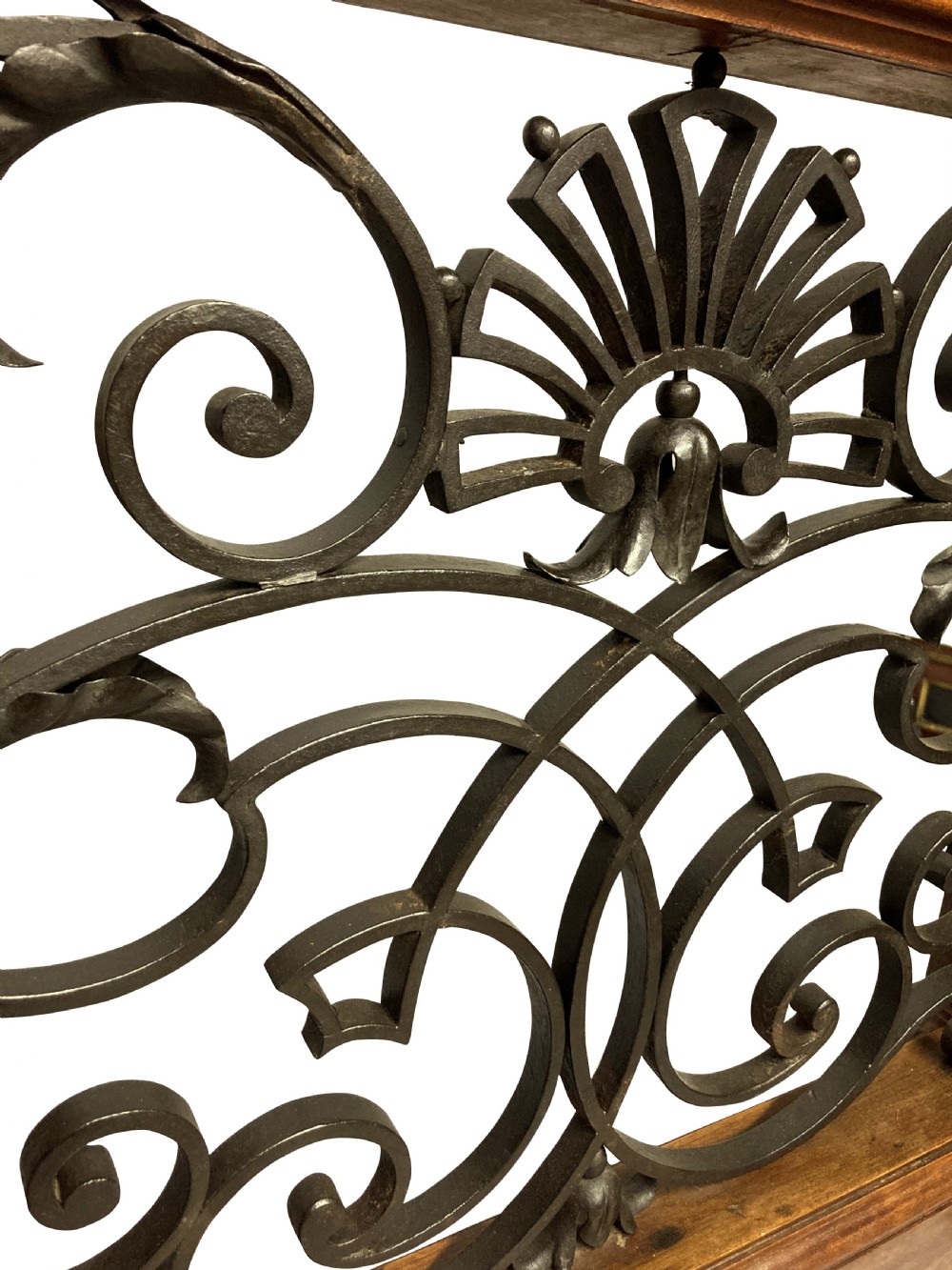 A pair of wooden-framed architectural balustrades featuring central wrought iron panels with scrolled patterns and fan motifs. View VIII