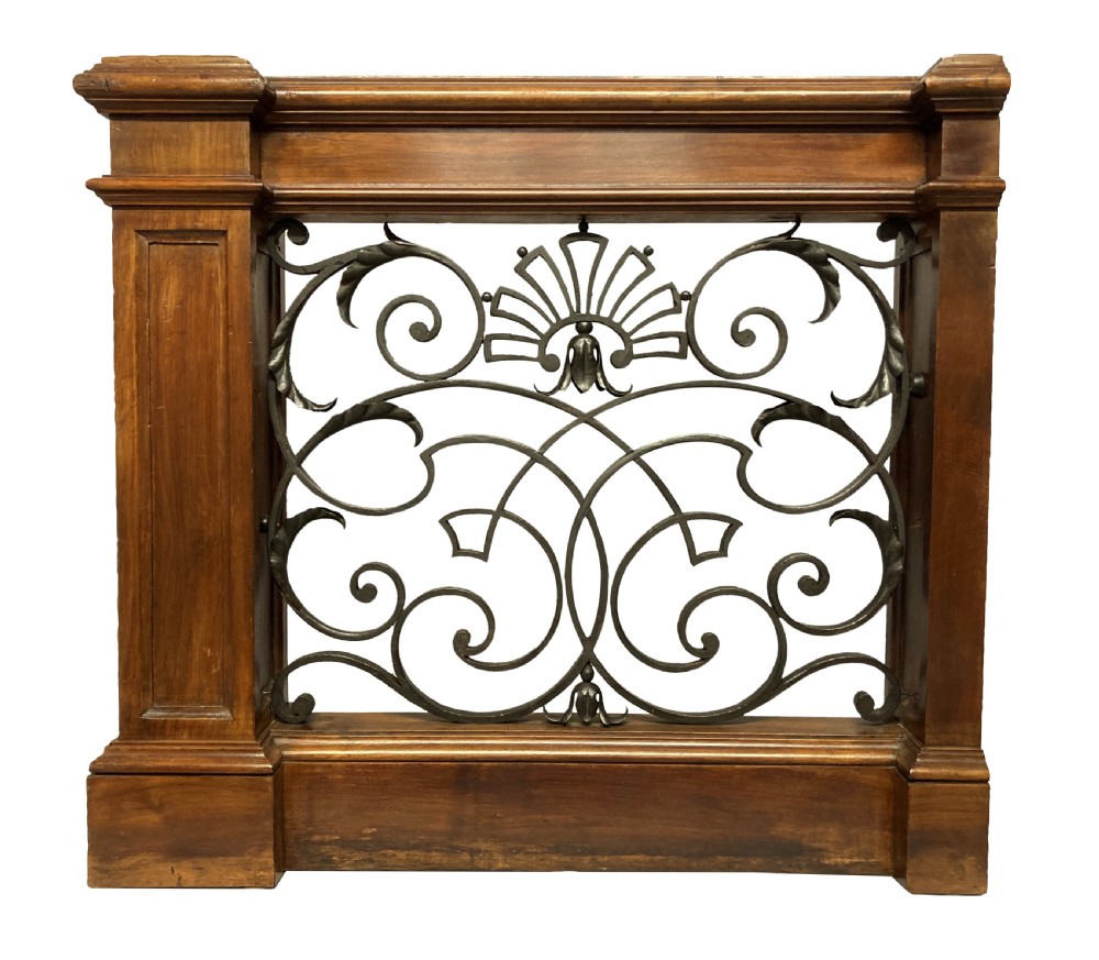 A pair of wooden-framed architectural balustrades featuring central wrought iron panels with scrolled patterns and fan motifs. View IX
