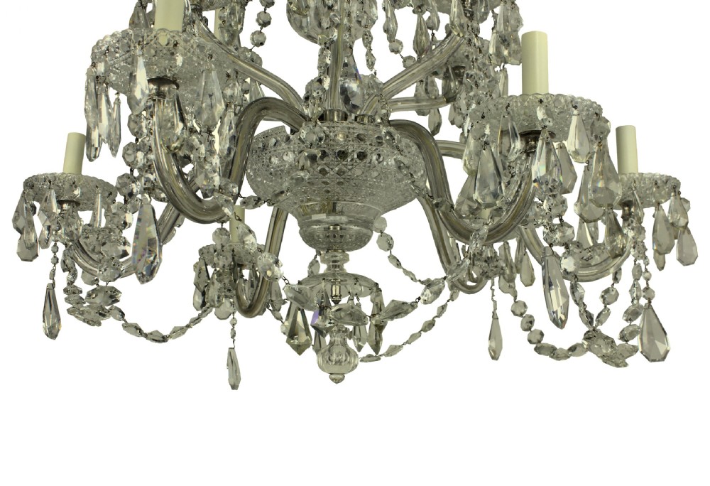 A multi-tiered nineteenth-century English cut glass chandelier featuring curved glass arms, faceted crystal drops, and glass candle sleeves. View III