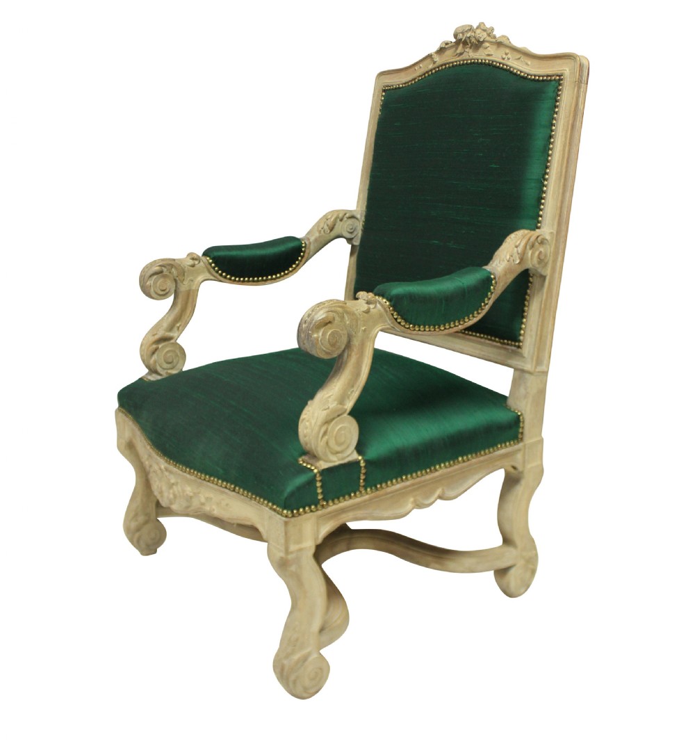 A Louis XIV style carved wood armchair upholstered in vibrant emerald green silk with brass stud details. View IV